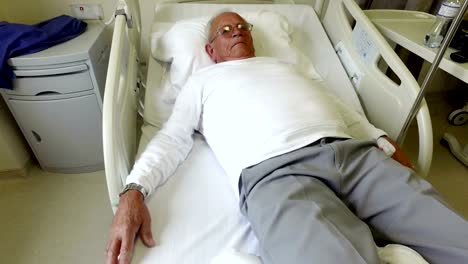 Elderly-80-plus-year-old-man-recovering-from-surgery-in-a-hospital-bed