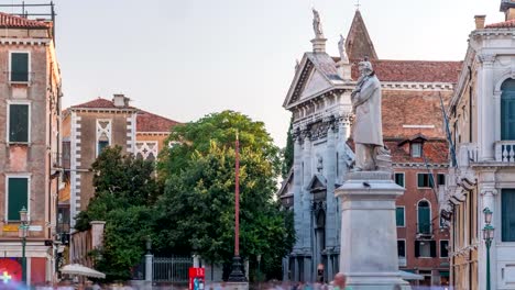 Tourists-around-the-monument-of-Niccolo-Tommaseo-timelapse-on-the-Campo-Santo-Stefano-city-square.-Venice,-Italy