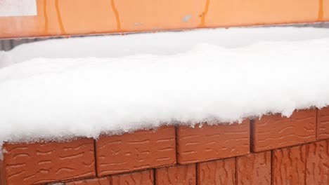 Stack-of-orange-clay-brick-with-snow-"For-sale"-words