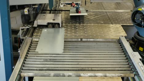 Robot-arm-in-a-metal-factory-picks-up-metal-plates