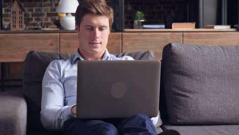 Guy-sitting-on-the-sofa-in-flat.