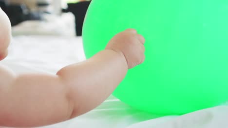 Cute-asian-little-baby-girl-having-fun-to-try-to-catch-and-play-with-balloon-in-slow-motion-shot