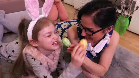 Mother-and-daughter-with-Easter-eggs-on-the-floor