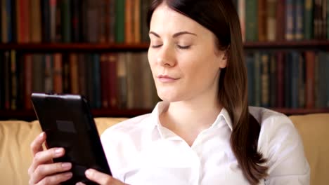 Woman-at-home-reading-e-book.-Paper-vs-digital-reading,-e-books-replacing-physical-print-books