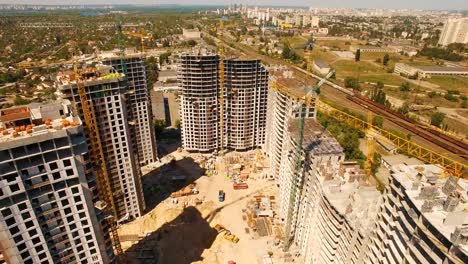 Aerial-shoot-of-construction-site-with-tower-cranes.-Construction-drone-footage