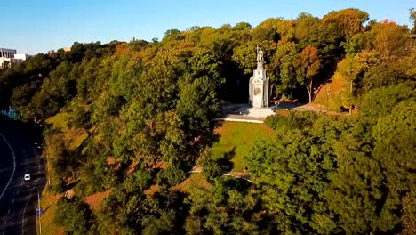 Kiev-down-town-(Kiyv)-Ukraine-Saint-Vladimir-Hill-video-footage.-Aerial-view-from-above.-the-camera-moves-up-and-opens-the-panorama-to-St.-Michael's-Golden-Domed-Monastery-and-Saint-Sophia's-Cathedral