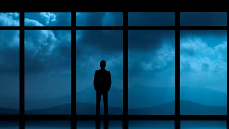 The-man-standing-near-panoramic-windows-on-a-cloud-stream-background.-time-lapse