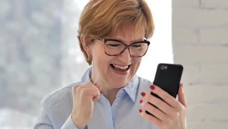 Old-Woman-Excited-for-Success-while-Using-Smartphone