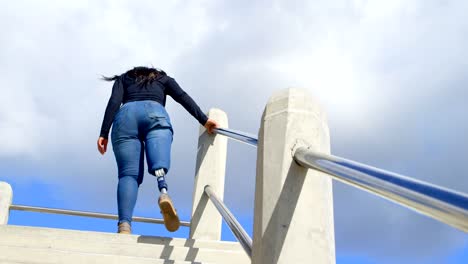 Disabled-woman-walking-upstairs-on-a-sunny-day-4k