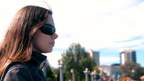 Young-brunette-woman-looking-at-the-sea-in-autumn