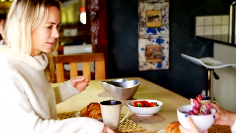 Lesbian-couple-having-breakfast-in-kitchen-4k