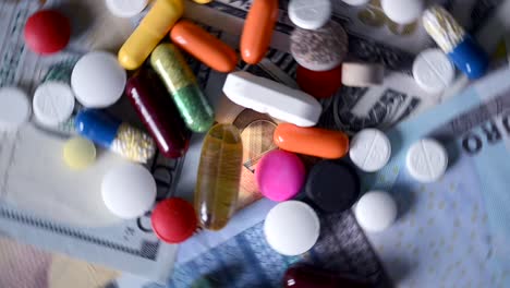 VIDEO,-healthcare-cost-concept-with-various-pills-and-pharmaceutical-drugs-rotating-on-cash-money