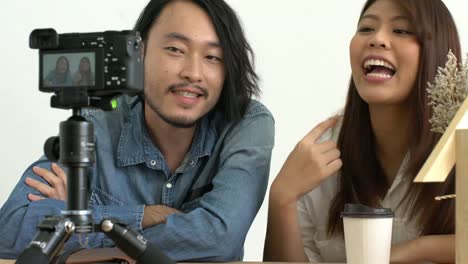 asian-couple-blogger-love-on-social-media-with-good-story-to-camera-home-background