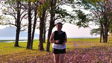 An-Asian-woman-jogging--in-natural-sunlight-in-the-evening.-She-is-trying-to-lose-weight-with-exercise-until-fatigue.--concept-health-with-exercise.-Slow-Motion