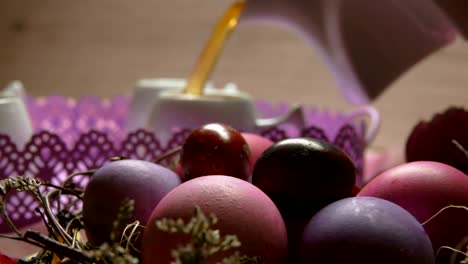 Colored-pink-Easter-egg-lies.-Tea-poured-in-the-cup