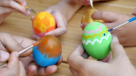 People-painting-colorful-Easter-eggs