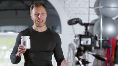 Sportsman-Telling-about-Supplements-on-Camera-while-Recording-Vlog