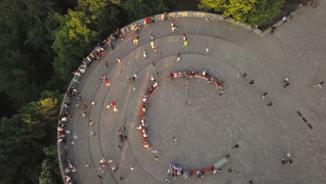 A-crowd-of-people-on-a-pedestrian-bridge-in-the-spring-evening.-Aerial-view.-A-new-bicycle-pedestrian-bridge-in-the-center-of-the-capital-of-Ukraine,-the-city-of-Kiev.-Excursions-and-walks-for-tourist