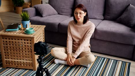 Female-blogger-recording-video-at-home-talking-and-gesturing-using-camera