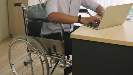 Disabled-man-on-wheelchair-working-in-the-office