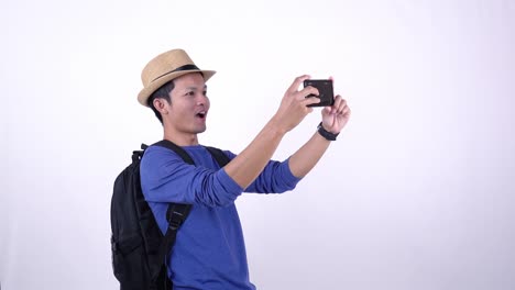 Asian-Thai-tourist-live-streaming-video-on-social-media-with-smart-phone-on-white-background