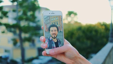 Close-up-of-man-speaking-on-video-call-on-smartphone