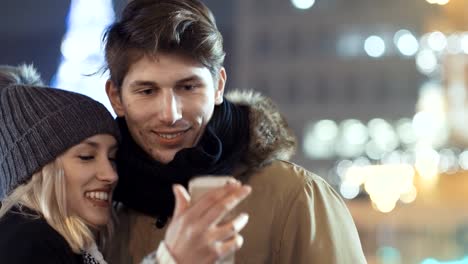 Young-happy-couple-making-winter-selfie-outdoor.