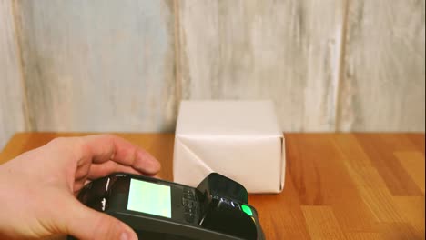 Close-up-view-process-of-contactless-payment.-Seller-put-the-payment-terminal