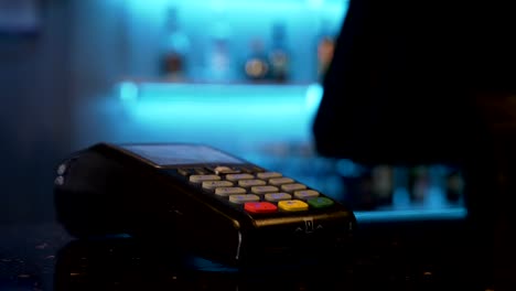 Customer-paying-with-smartphone-at-restaurant-pub-using-pos-and-contactless-wireless-technology