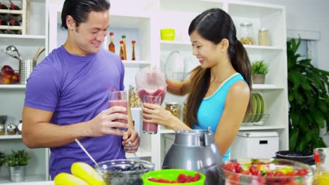 Happy-Asian-Chinese-couple-making-organic-fruit-drink