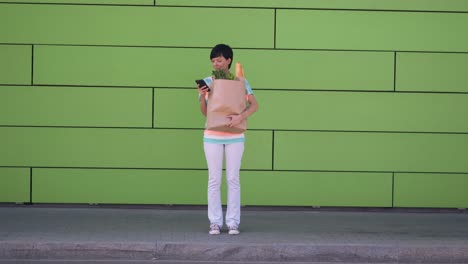 Lady-with-purchases-messaging-after-left-grocery-store