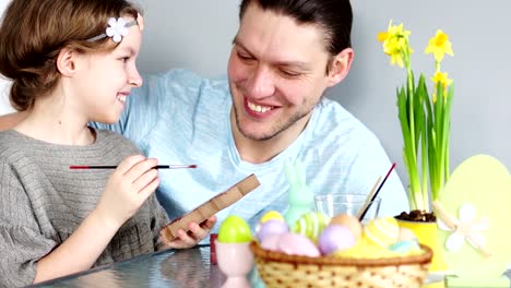 Daughter-and-father-are-preparing-for-the-celebration-of-Easter.-Easter-traditions.-The-father-hugs-the-girl-and-kisses-him-tenderly.-They-laugh-for-a-long-time