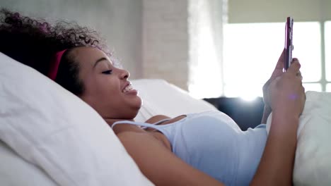 Teen-Using-Mobile-Telephone-For-Chat-In-Bed-At-Home