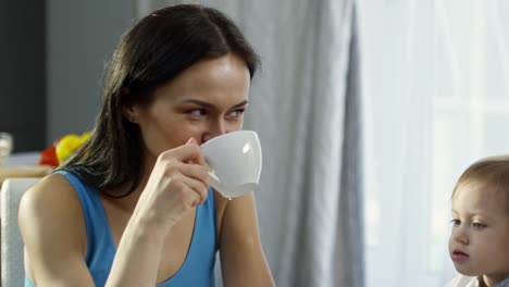 Happy-Female-Couple-Having-Breakfast-with-Toddler