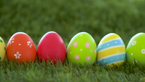 row-of-colored-easter-eggs-on-artificial-grass