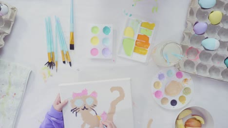 Little-girl-and-her-mom-painting-Easter