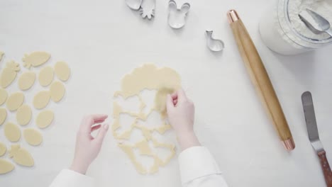 Cutting-sugar-cookie-dough-with-Easter-shaped-cookie-cutters.