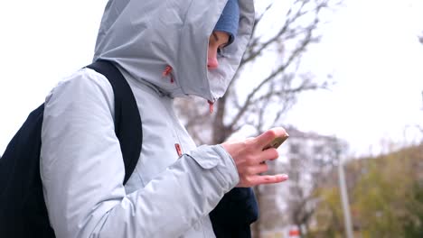 Woman-got-lost-in-the-city-and-looking-for-a-route-using-the-Navigator-in-the-mobile-phone.