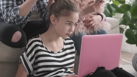 Teenage-girls-using-laptop-and-mobile-phones