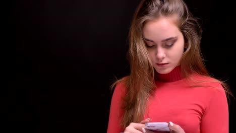 Closeup-portrait-of-young-caucasian-beautiful-female-browsing-on-the-phone-and-reacting-to-social-media-posts