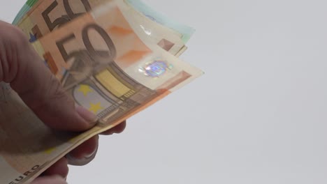 Slow-motion-Close-up-hands-counting-euros-bills-of-fifty-and-one-hundred.