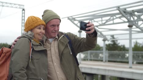 Senior-Couple-Making-Selfie-on-Train-Station