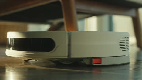 Close-up-of-the-robotic-vacuum-cleaner-riding-around-and-cleaning-up-apartments