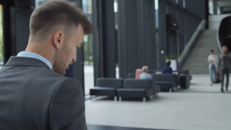 Businessman-Having-Telephone-Conversation-in-Airport