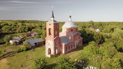 Aerial-view-of-the-Russian-forest,-river-and-steppe-overlooking-an-abandoned-Church-and-architectural-objects