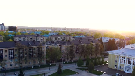 Drone-Flies-over-Square-with-Jumping-Fountains-Buildings