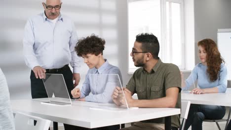 Group-of-Young-People-Learning-to-Use-Futuristic-Devices-in-Class