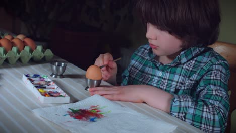 4K-Home-Shot-Of-Child-Painting-Easter-Eggs