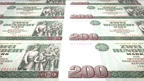 Banknotes-of-two-hundred-german-marks-or-deutschmarks-of-the-bank-of-the-old-German-republic-rolling-on-screen,-coins-of-the-world,-cash-money,-loop