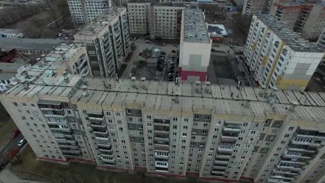 Aerial-survey-on-city.-View-from-the-sky-on-Russian-city.-Aerial-city-view-on-houses,-streets-and-parks.-Grey-sky-and-garages-really-residential-district.-Aerial-survey-on-the-street-where-drive-a-lot-of-car.Chelyabinsk.-Ural.-Overhead-Aerial-Flight-Over